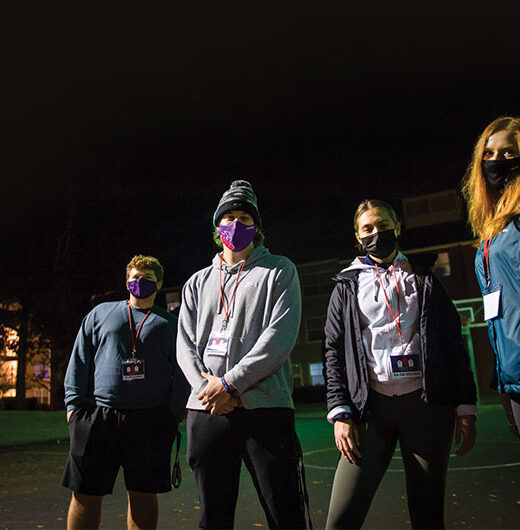 Four resident advisors standing outside at night about to go on their rounds throughout the south side of campus: Samuel Dixon '24, Evan Bates '22, Carmel Wolff '23 and Kelsey Jordan '23.