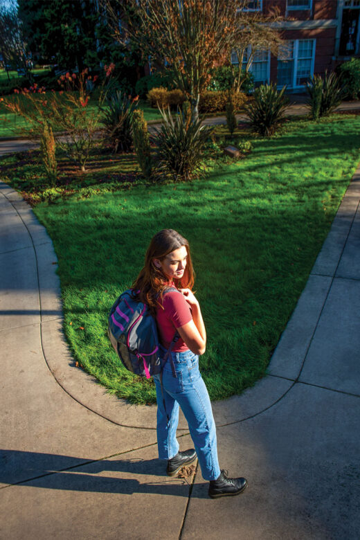 Elise Bedford '22 walking on a path in the academic quad