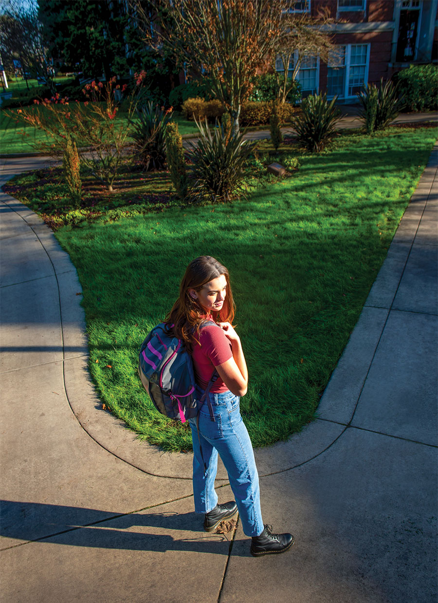 Elise Bedford '22 walking on a path in the academic quad