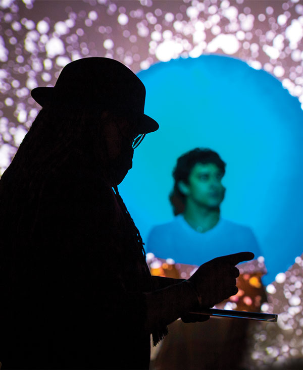 Kahlil working on a digital art piece with a Linfield student