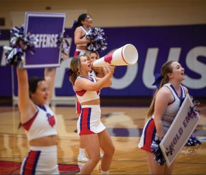 Linfield cheer performing at a basketball game