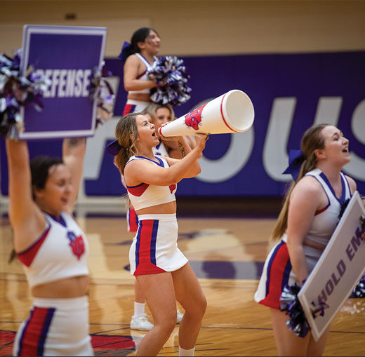 Linfield cheer performing at a basketball game