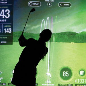 Picture of someone using the golf simulator.