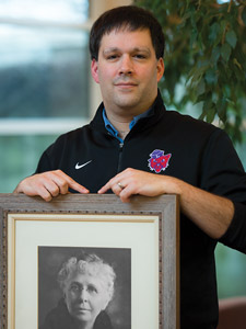 Rich Schmidt holding a framed picture of Mrs. Linfield