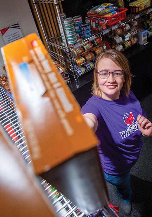 Student worker stocking shelves.