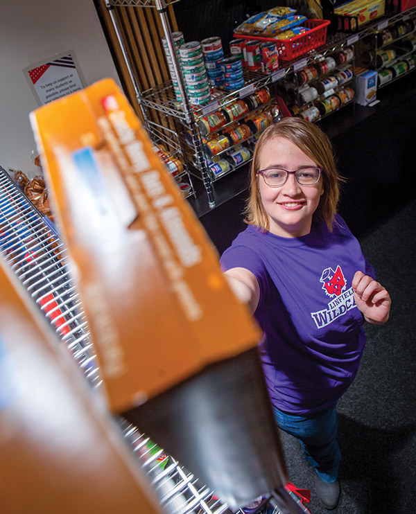 Student worker stocking shelves.