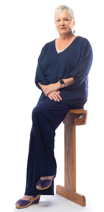Portrait of Dawn Nowacki sitting on a stool
