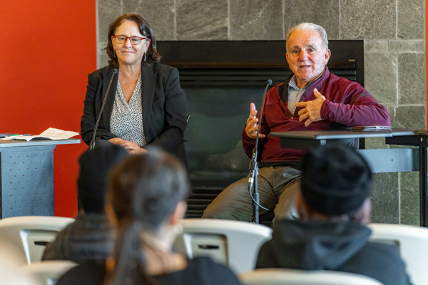 Therese Bottomly and Steve Kurkjian speaking to the Linfield community in the library.