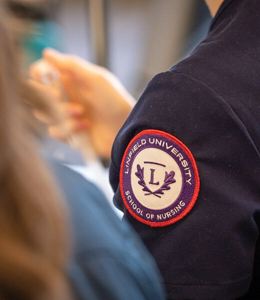 Linfield University School of Nursing patch on student scrubs.