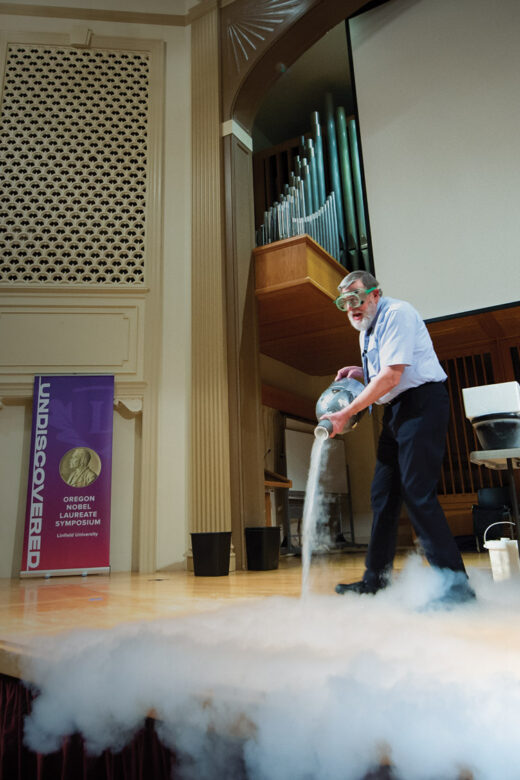 Nobel laureate Bill Phillips performing an experiment on stage.