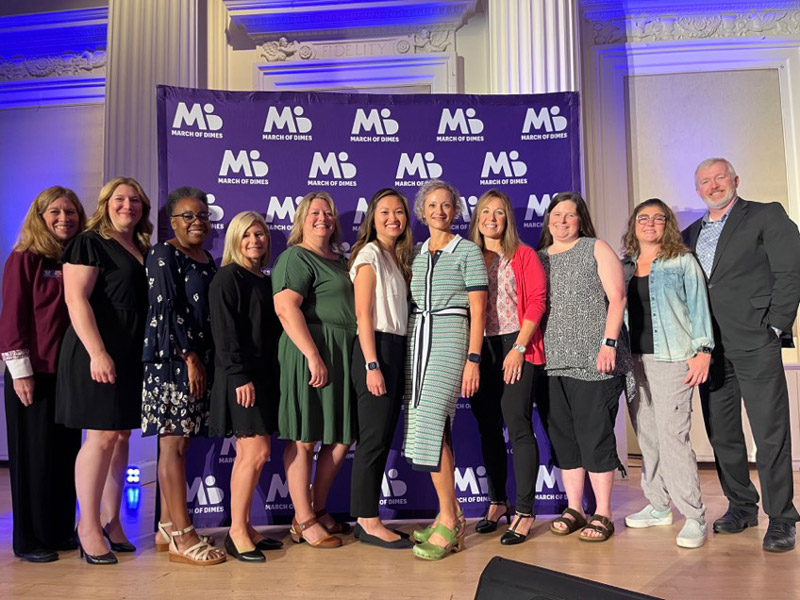 Nine Linfield Alumni honored at the March of Dimes Heroes in Action awards ceremony with two members of Linfield's administration team.