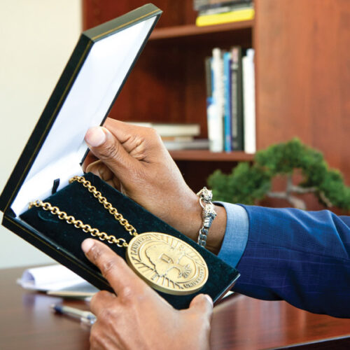 President Davis holding the President's Medallion in its box.
