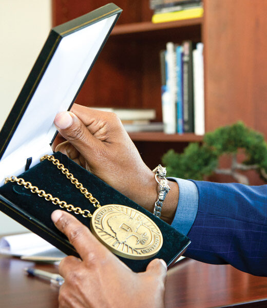 President Davis holding the President's Medallion in its box.