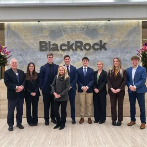 Jan term class posing for a photo in front of the Blackrock sign.