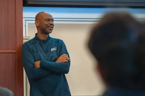 Damian teaching in a classroom.