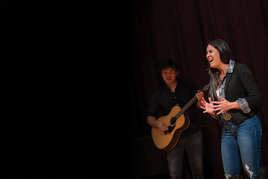 Jessie G and guitarist Christian Santangelo perform on the Delkin Recital Hall stage.