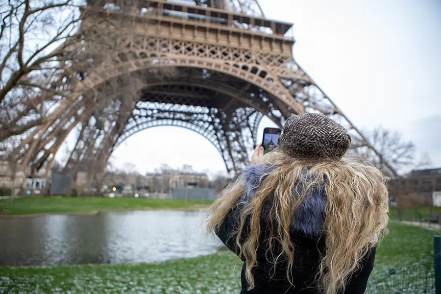 student taking a photo of the Eiffel Tower.