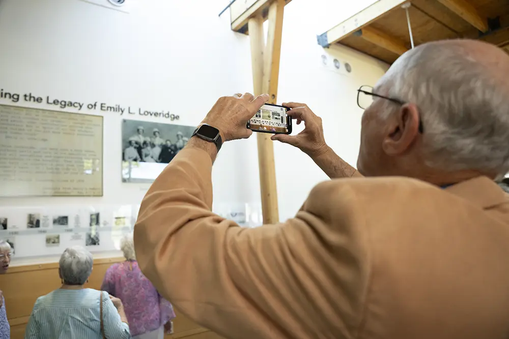 An attendee taking a photo of the exhibit.