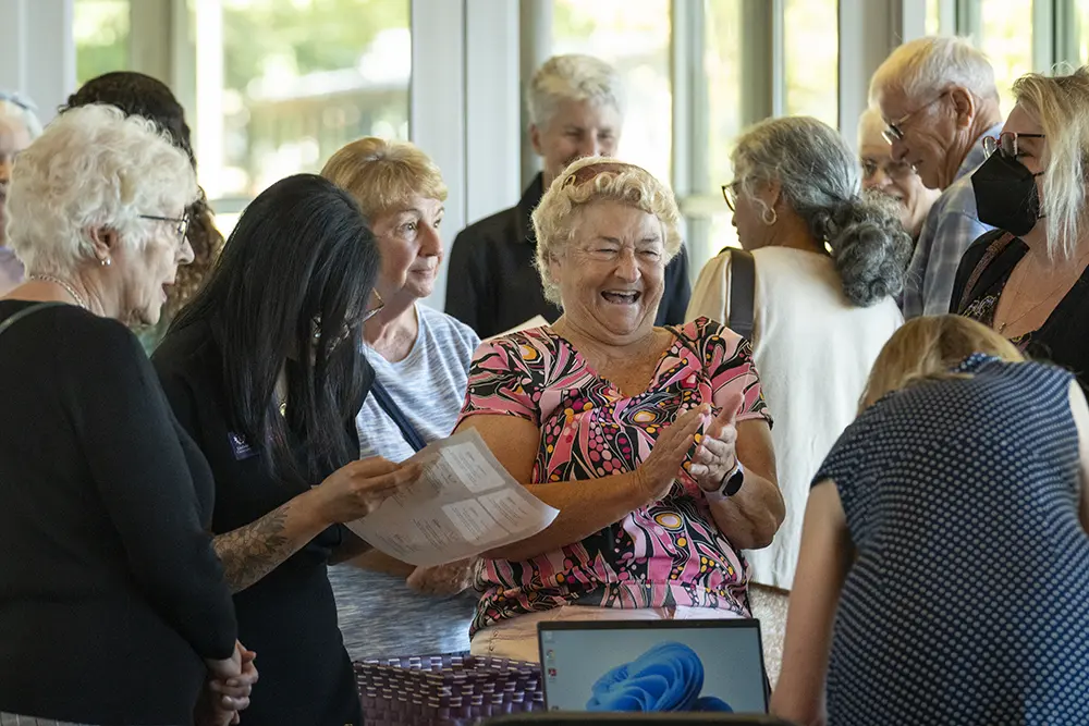 Candid photo of attendees smiling.