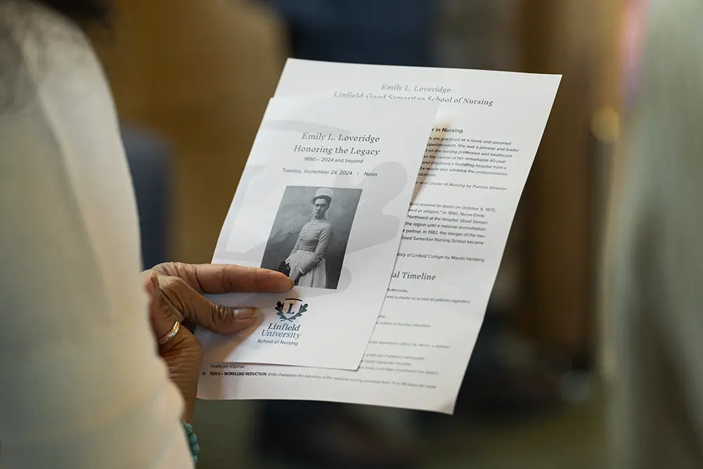 Close up of the event program being held by an attendee.